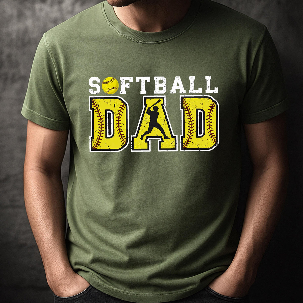 May include: A green t-shirt with the text "Softball Dad" in white and yellow. A silhouette of a softball player is in the middle of the word "Dad".