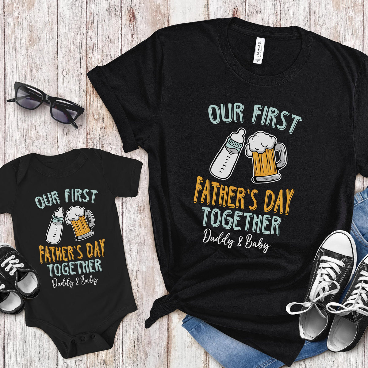 May include: A black bodysuit and t-shirt set with the text "Our First Father's Day Together Daddy & Baby". The design features a baby bottle and a beer mug.