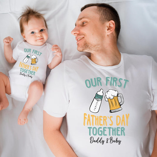 May include: A white onesie and t-shirt set with the text "Our First Father's Day Together Daddy & Baby". The onesie has a baby bottle and a beer mug with a foam top. The t-shirt has a baby bottle and a beer mug with a foam top.