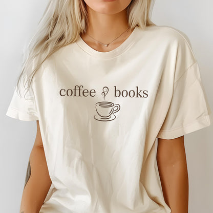 May include: An off-white short-sleeve t-shirt featuring the dark brown text coffee books with a graphic of a steaming coffee cup centered on the chest. The garment has a crew neckline and a relaxed fit, showcasing a simple graphic design.