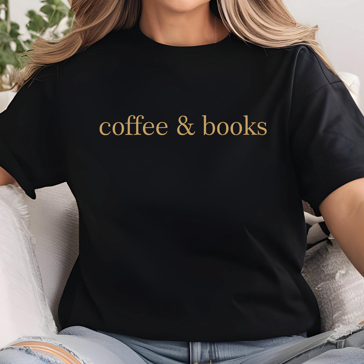 May include: A black short-sleeved t-shirt featuring the text "coffee & books" printed in a gold-colored font across the chest. The garment has a crew neckline and a standard fit, providing a simple and clear display of the printed lettering.