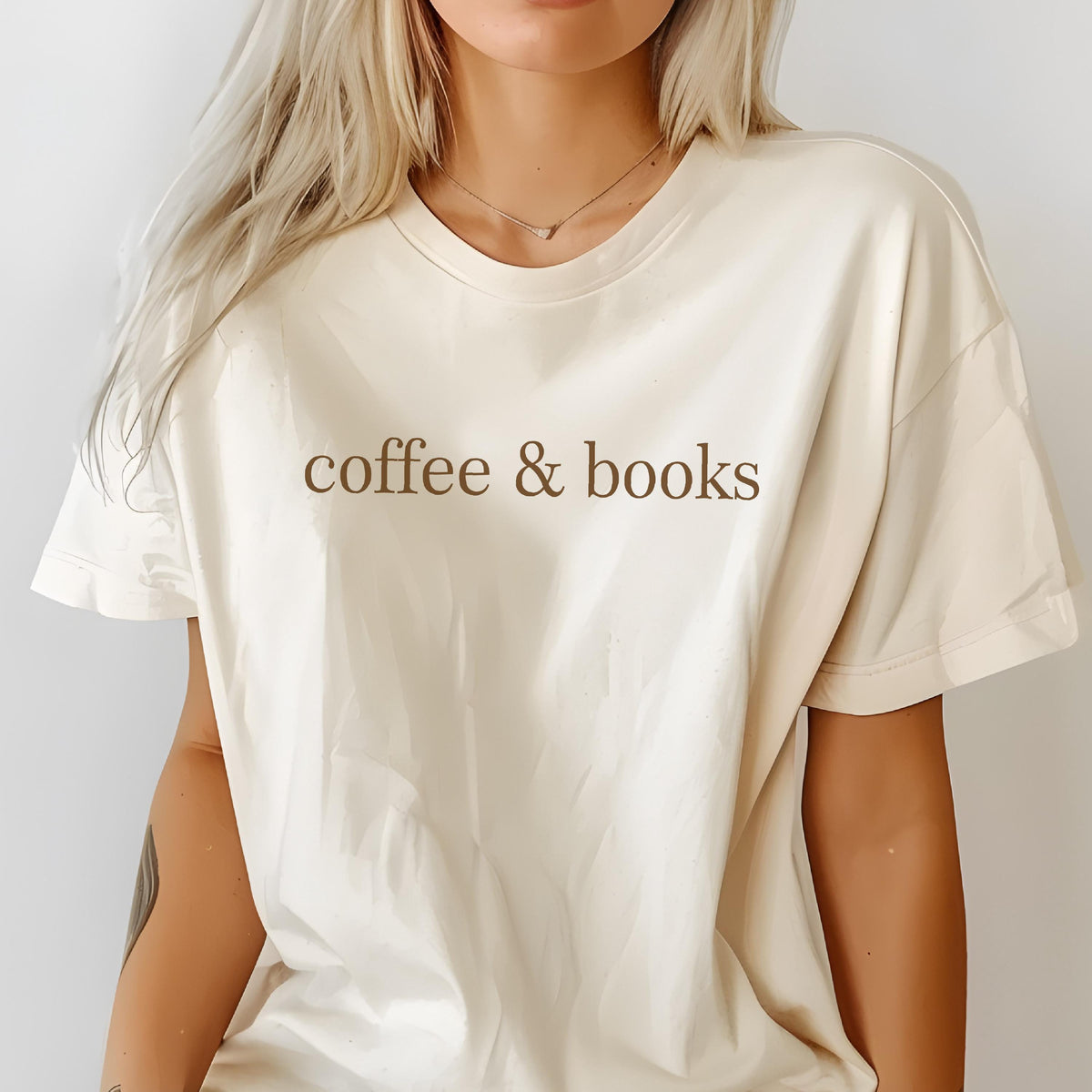 May include: A cream colored t-shirt with the text "coffee & books" printed in brown on the front.