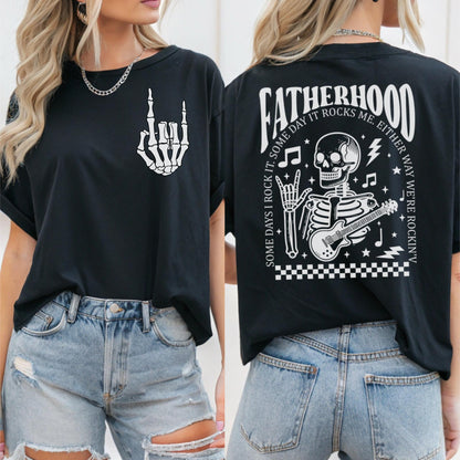 May include: Black t-shirt with a white skeleton playing a guitar and the text "Fatherhood Some days I rock it. Some day it rocks me. Either way we're rockin'" on the back. The front of the shirt has a white skeleton hand making a rock and roll sign.