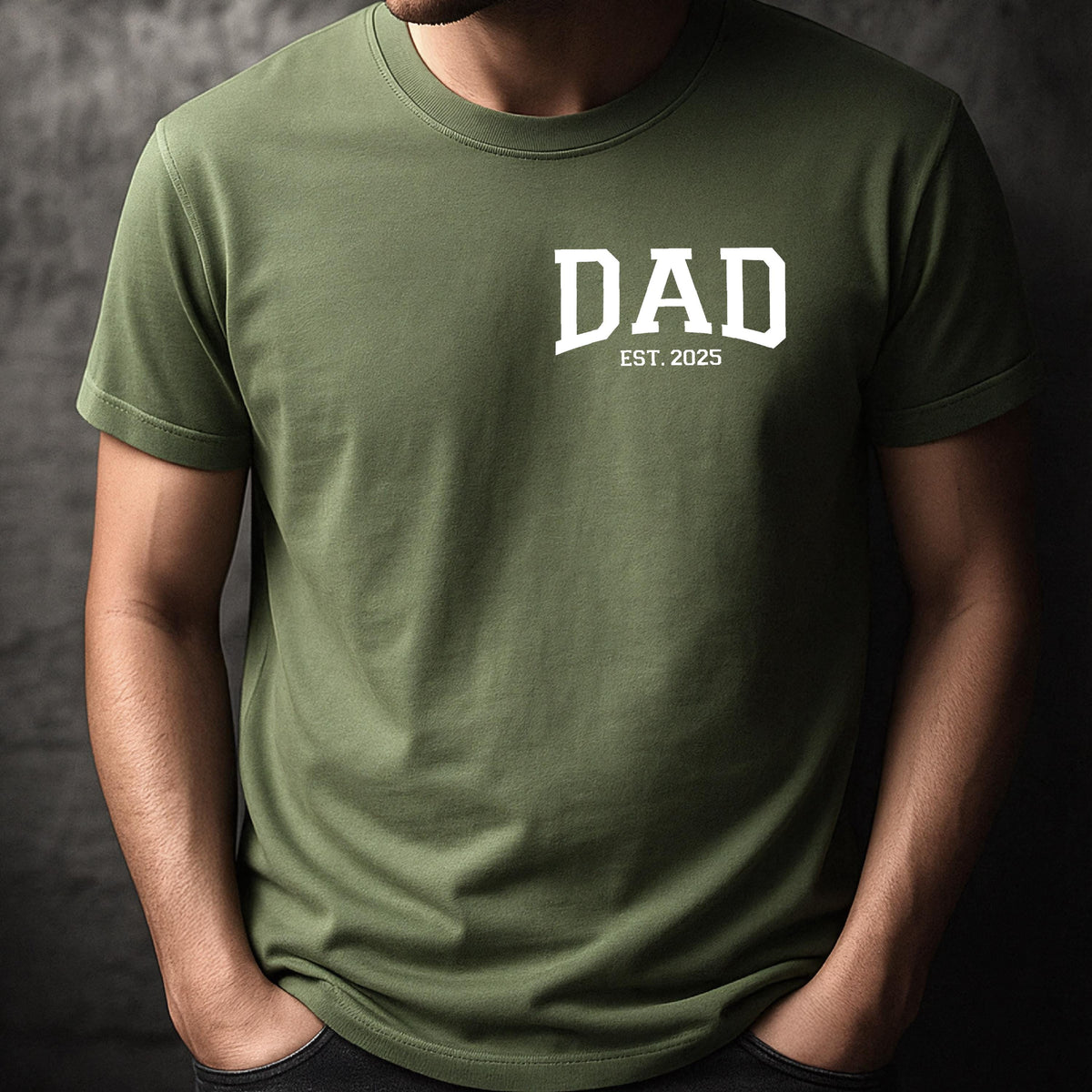 May include: A green short-sleeved t-shirt with the word "DAD" in white block letters and the text "EST. 2025" underneath.