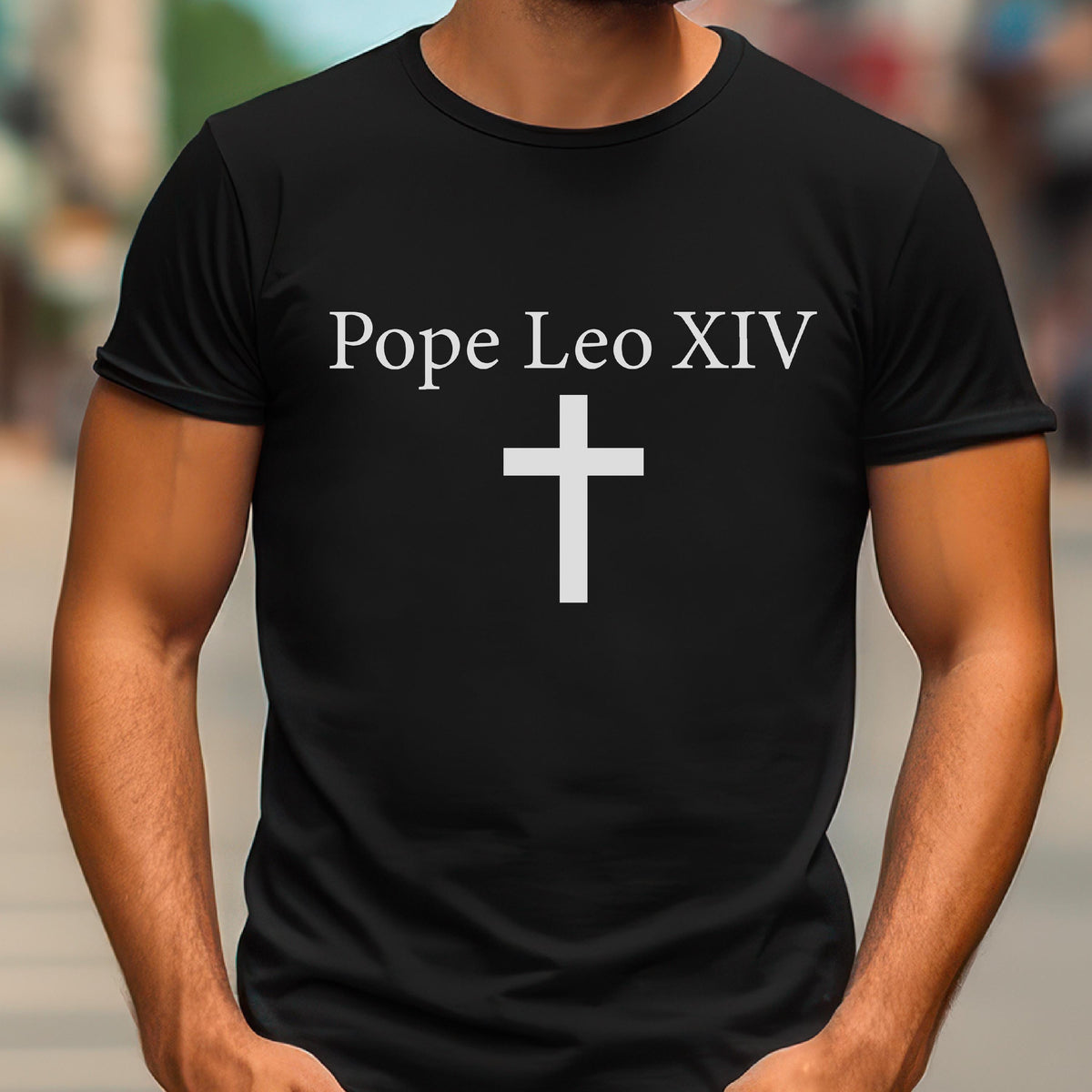 May include: Black t-shirt with the text "Pope Leo XIV" above a white cross. The shirt is a crew neck style and appears to be made of a soft material. The design is simple and centered on the front of the shirt.