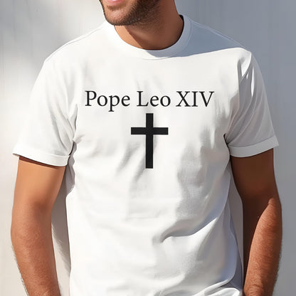 May include: White t-shirt with the text "Pope Leo XIV" above a black cross. The shirt has short sleeves and a crew neck. The design is centered on the chest.