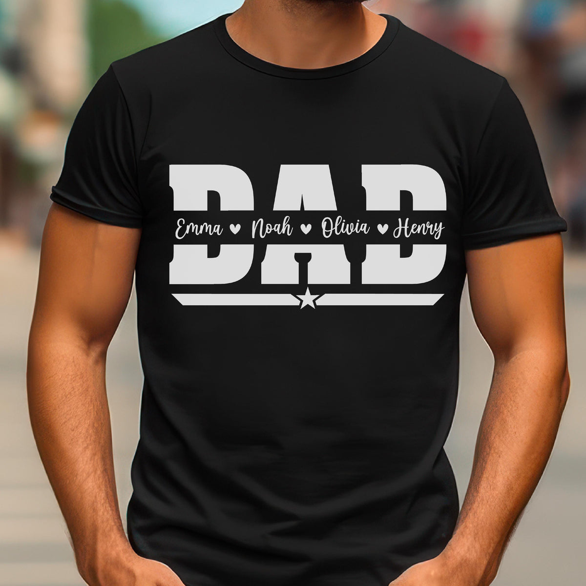 May include: Black t-shirt with the word "DAD" in large white letters. Below the word "DAD" are the names Emma, Noah, Olivia, and Henry, each with a heart symbol. A star is below the word "DAD".
