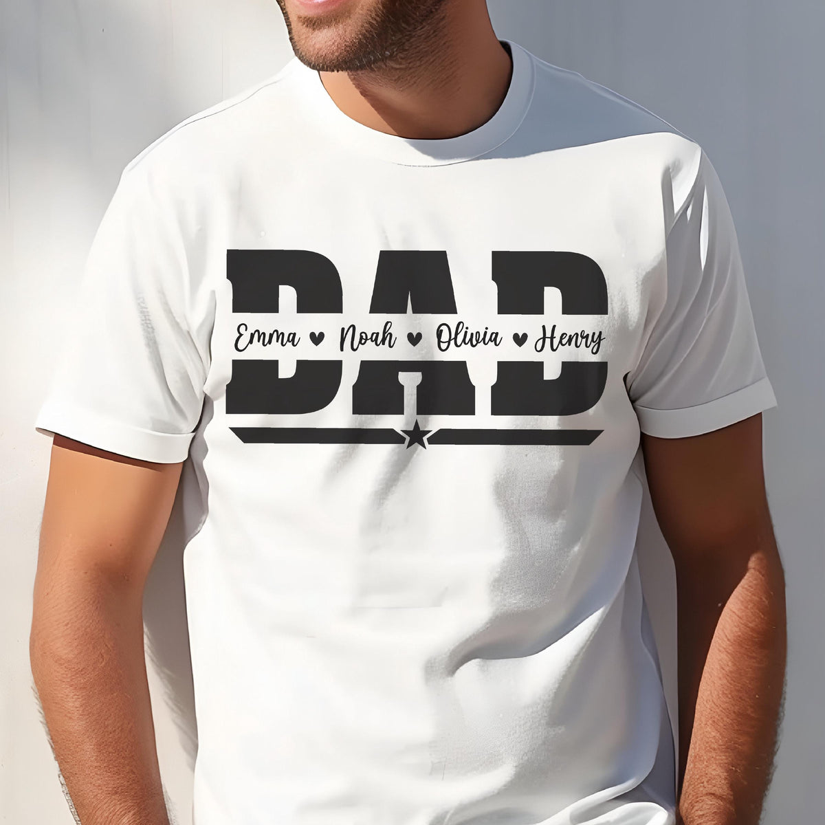 May include: White t-shirt with a black graphic that says "DAD" in bold letters. Below the word "DAD" are the names "Emma", "Noah", "Olivia", and "Henry", each with a heart symbol. A star is centered below the names.