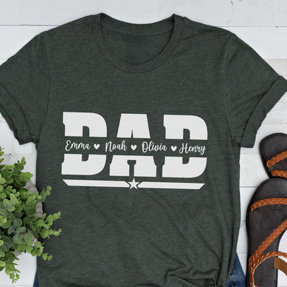 May include: Dark gray t-shirt with the word "DAD" in large white block letters. Below the word "DAD" are the names "Emma", "Noah", "Olivia", and "Henry" in white, separated by hearts. A white star is below the names.