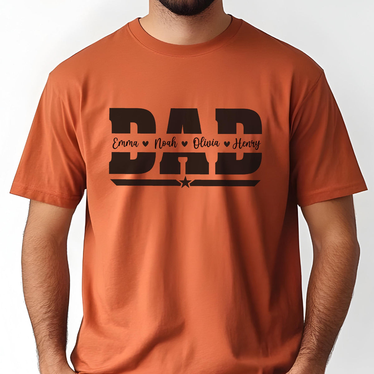 May include: An orange t-shirt with the word "DAD" in large, black block letters. Below the word "DAD" are the names Emma, Noah, Olivia, and Henry, each with a heart symbol. A small star is centered below the names.