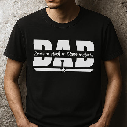 May include: Black t-shirt with the word "DAD" in large white block letters. Below the word "DAD" are the names Emma, Noah, Olivia, and Henry, each with a heart symbol. A white star is centered below the names.