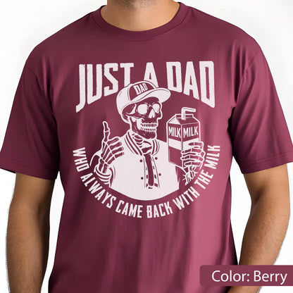 May include: Berry-colored t-shirt with a white graphic of a skeleton wearing a baseball cap and jacket, holding a milk carton. The text reads "JUST A DAD" and "WHO ALWAYS CAME BACK WITH THE MILK".