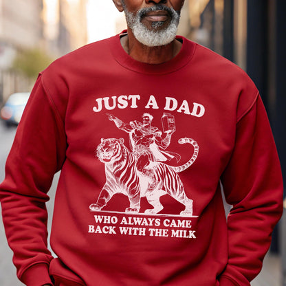 May include: Red sweatshirt with a white graphic of a superhero riding a tiger, holding a milk carton. The text reads "JUST A DAD WHO ALWAYS CAME BACK WITH THE MILK."