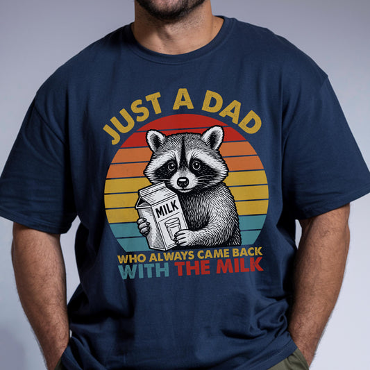May include: Navy blue t-shirt featuring a raccoon holding a milk carton. The design includes a retro sunset and the text "JUST A DAD WHO ALWAYS CAME BACK WITH THE MILK" in yellow and white.