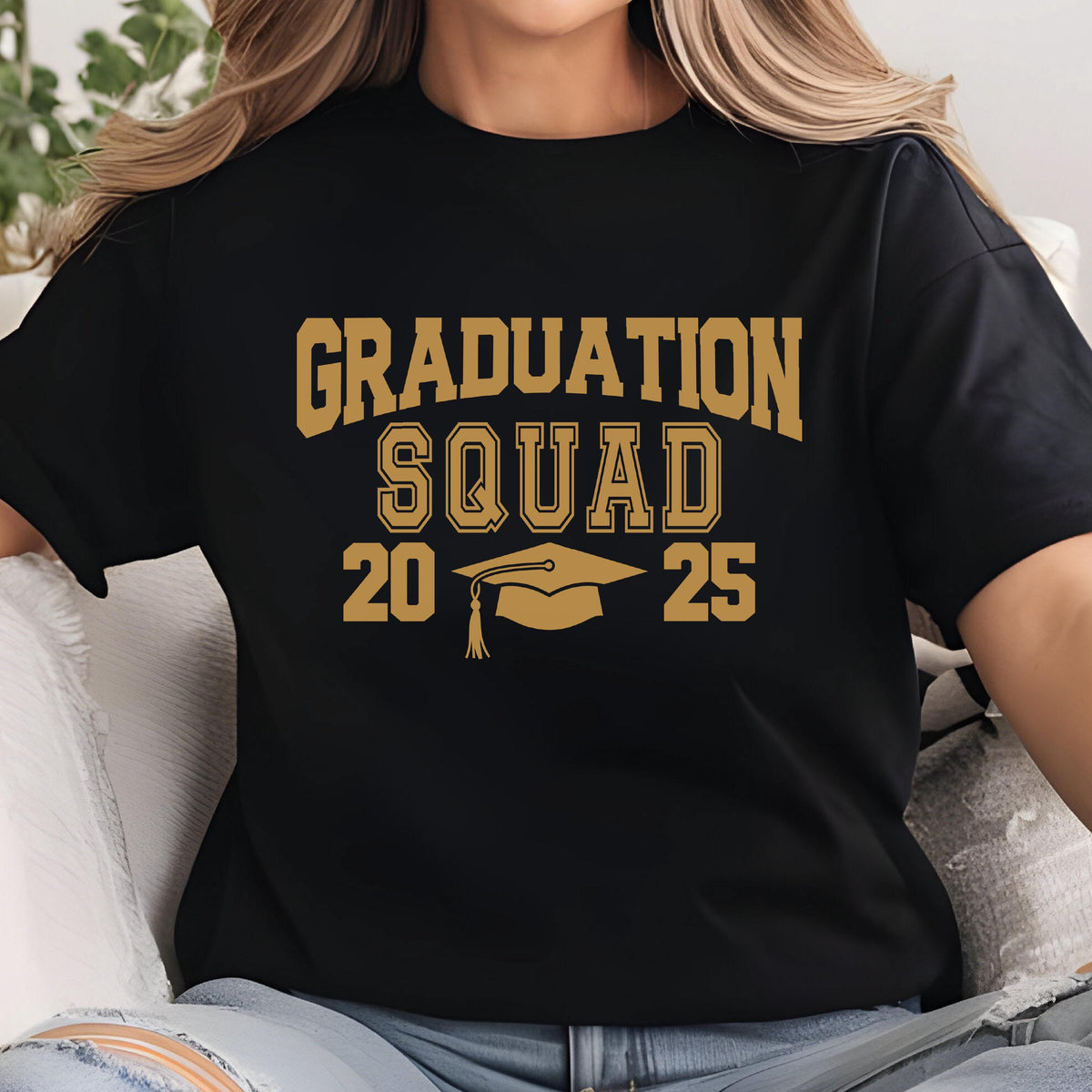 May include: Black t-shirt with the words "GRADUATION SQUAD 2025" in gold lettering. A graduation cap graphic is centered below the word "SQUAD". The shirt is a crew neck style.