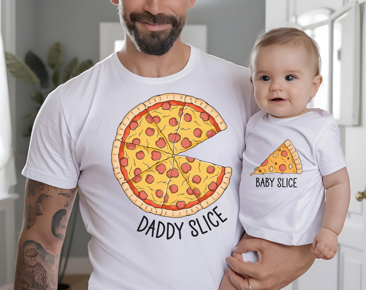 May include: White t-shirts with pizza slice graphics. One shirt features a full pizza with the text "Daddy Slice," while the other has a single slice and the text "Baby Slice." The shirts are worn by a parent and child.