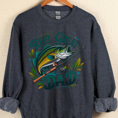 May include: Dark gray sweatshirt with a graphic of a fish, fishing rod, and the words "Reel Great Dad" in teal and green. The fish is yellow, green, and white. The sweatshirt is hanging on a wooden hanger.