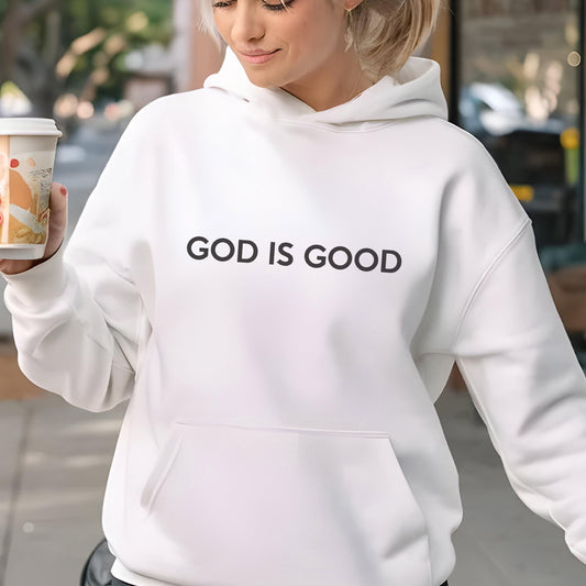 May include: White hoodie with the text "GOD IS GOOD" in black. The hoodie has a front pocket and a hood. The person in the image is holding a coffee cup.