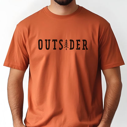 May include: A burnt orange short-sleeved t-shirt featuring the black text "OUTSIDER" printed across the chest. The letter "I" in the word is replaced by a stylized black graphic of a pine tree. The shirt has a crew neckline and a plain back.