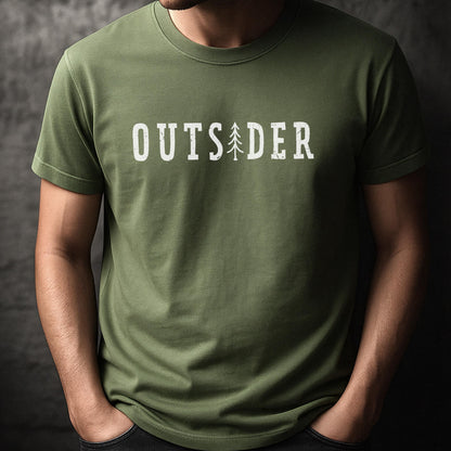 May include: An olive green short-sleeved crew neck t-shirt featuring the white text "OUTSIDER" printed across the chest. The letter "I" in the word is replaced by a stylized graphic of a tall, thin evergreen tree with a distressed texture.