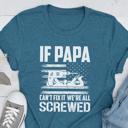 May include: Teal t-shirt with the text "IF PAPA CAN'T FIX IT WE'RE ALL SCREWED." The design includes a drill and a hand plane, set against a stylized American flag. A casual, humorous design.