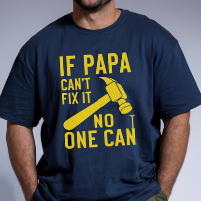 May include: Navy blue t-shirt with a yellow hammer graphic and the text "IF PAPA CAN'T FIX IT NO ONE CAN". The shirt has a crew neck and short sleeves.