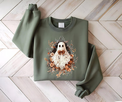 May include: Olive green sweatshirt featuring a ghost design with a floral wreath and a brown bow tie. The ghost has a white sheet with a lace trim. The sweatshirt has long sleeves and a crew neck.