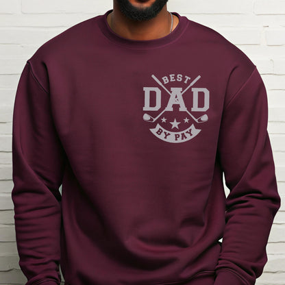 May include: A maroon sweatshirt with a gray graphic that reads "BEST DAD BY PAY". The graphic includes crossed golf clubs, stars, and the word "DAD" in bold letters. The sweatshirt is a solid color and has a crew neck.