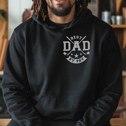 May include: Black hoodie with a gray graphic that reads "BEST DAD BY PAY" in a circular design with golf clubs and stars. The hoodie has a front pocket and a hood. The person wearing the hoodie is smiling.
