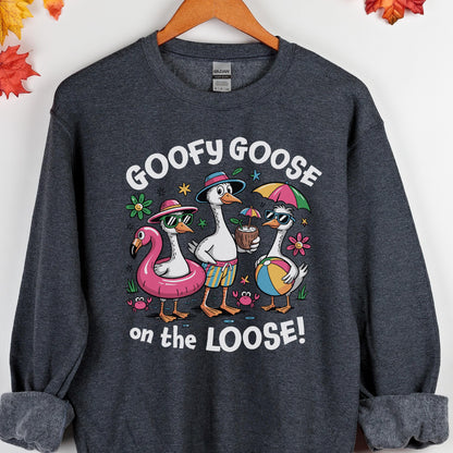 May include: Dark gray sweatshirt with a graphic of three cartoon geese in sunglasses and beach attire. The text "GOOFY GOOSE" is above the geese, and "on the LOOSE!" is below. The geese are surrounded by flowers and a flamingo float.