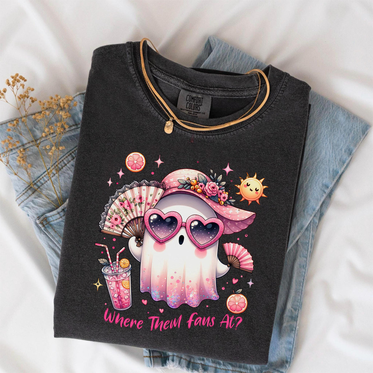 May include: Dark gray Comfort Colors t-shirt featuring a cartoon ghost wearing heart-shaped sunglasses and a pink hat. The ghost is holding a fan and a drink. The text "Where Them Fans At?" is printed on the shirt.