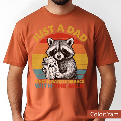 May include: Yam-colored t-shirt featuring a raccoon holding a milk carton. The design includes a sunset background and the text "JUST A DAD WHO ALWAYS CAME BACK WITH THE MILK."