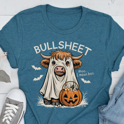 May include: Teal t-shirt featuring a cartoon cow dressed as a ghost, holding a jack-o'-lantern filled with candy corn. The text "BULLSHEET" is above the cow, with "moo... I mean boo" below. Bats are also featured.