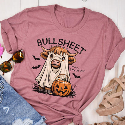 May include: Dusty rose t-shirt with a Halloween-themed graphic. The graphic features a cow in a ghost costume, a jack-o'-lantern, and the text "BULLSHEET" above and "Moo... I mean boo" below.
