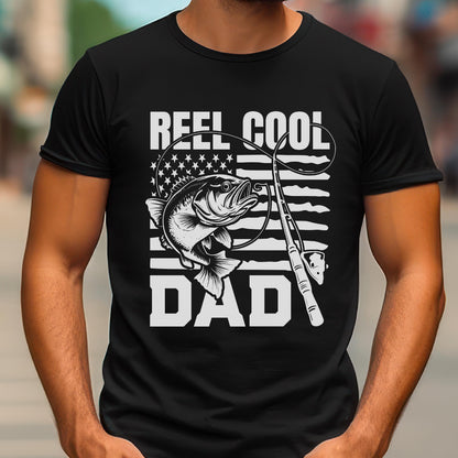 May include: Black t-shirt with a white graphic featuring a fish, fishing rod, and the words "REEL COOL DAD." The design incorporates the American flag. A great gift for fishing enthusiasts.