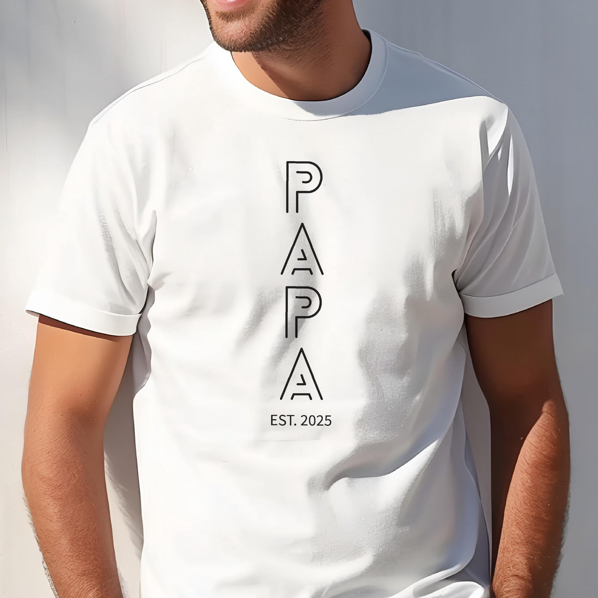 May include: White t-shirt with the word "PAPA" in black, vertically aligned, with the text "EST. 2025" below. The shirt has short sleeves and a crew neck.