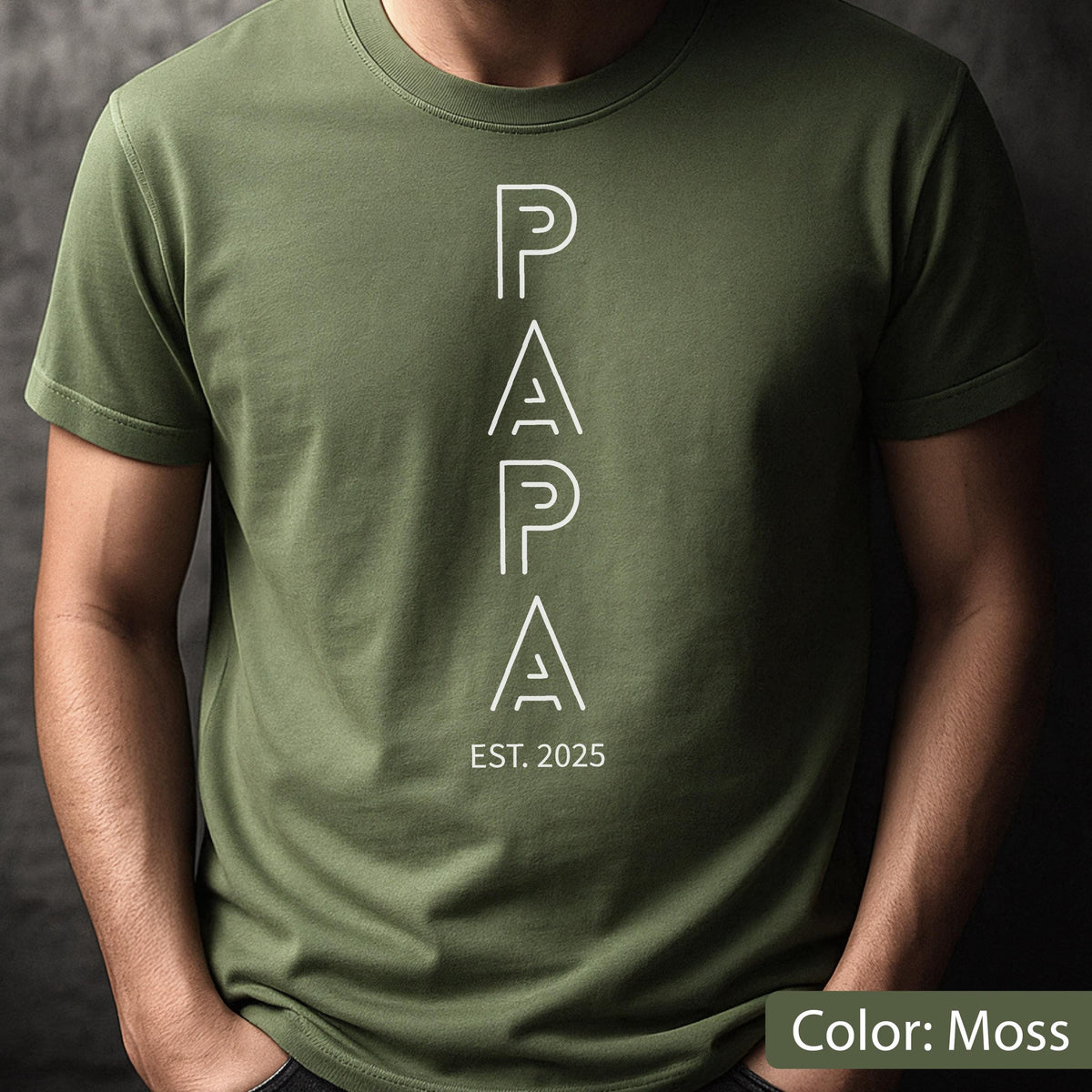 May include: Moss green t-shirt with the word "PAPA" in white, vertically aligned, with "EST. 2025" below. The shirt is a solid color and has short sleeves.