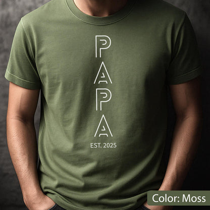 May include: Moss green t-shirt with the word "PAPA" in white, vertically aligned, with "EST. 2025" below. The shirt is a solid color and has short sleeves.