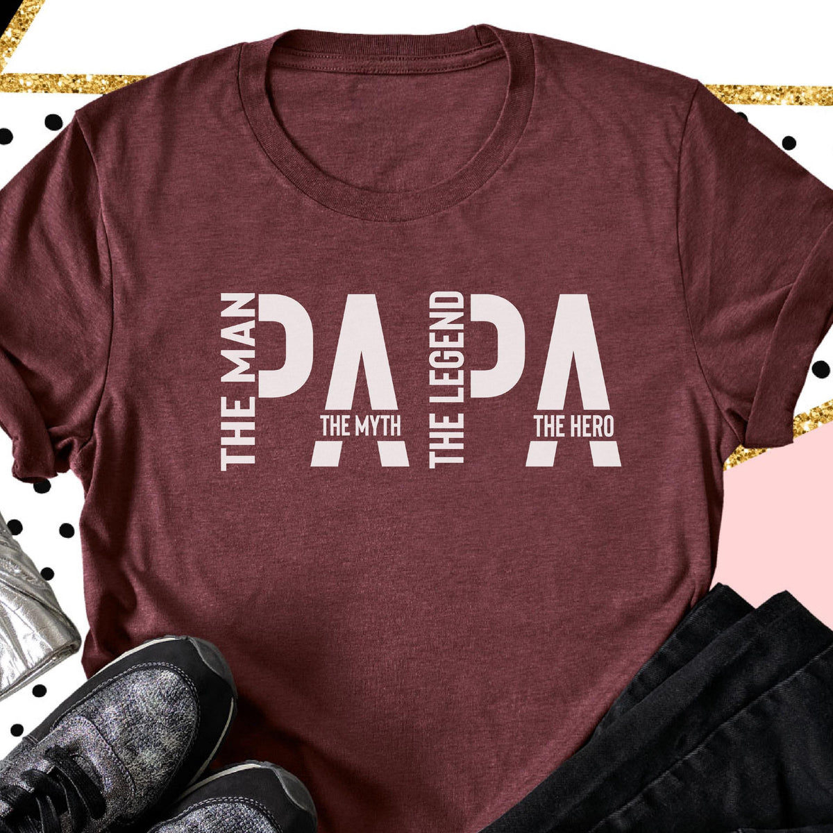 May include: Maroon t-shirt with the word "PAPA" in large white letters. The words "THE MAN", "THE MYTH", "THE LEGEND", and "THE HERO" are vertically printed on the left and right sides of the word "PAPA".