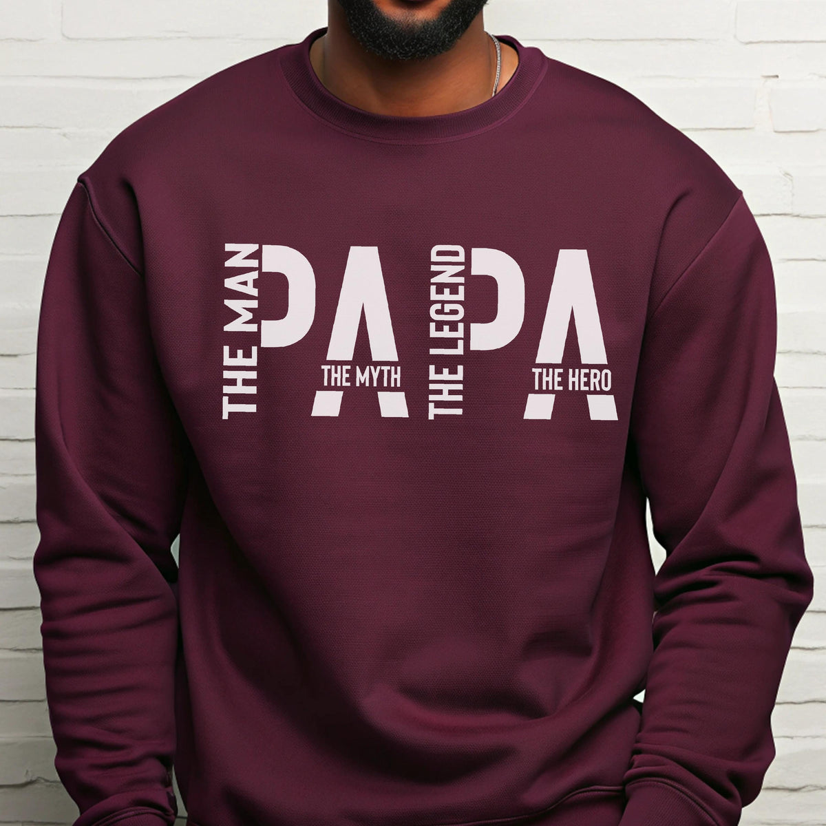 May include: A maroon sweatshirt with the word "PAPA" in large white letters. The text "THE MAN, THE MYTH, THE LEGEND, THE HERO" is printed vertically and horizontally around the word "PAPA".