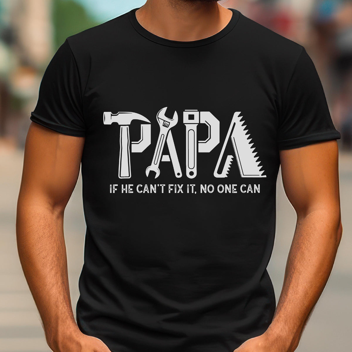May include: Black t-shirt with the word "PAPA" in white, with each letter designed as a tool: a hammer, wrench, and saw. The text "IF HE CAN'T FIX IT, NO ONE CAN" is below the word "PAPA".