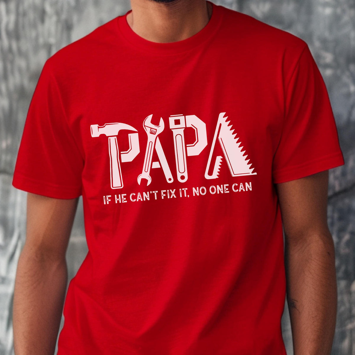 May include: Red t-shirt with the word "PAPA" in white, designed with tool graphics. The text "IF HE CAN'T FIX IT, NO ONE CAN" is below the word "PAPA".