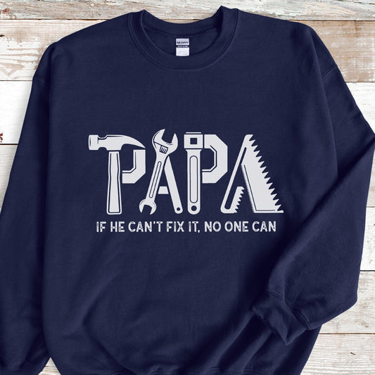 May include: Navy blue sweatshirt with the word "PAPA" in white, designed with tool graphics. The text "IF HE CAN'T FIX IT, NO ONE CAN" is below the word "PAPA".