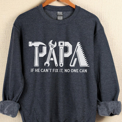 May include: A navy blue sweatshirt with the word "PAPA" in white, with each letter designed as a tool: a hammer, wrench, adjustable wrench, and saw. The text "IF HE CAN'T FIX IT, NO ONE CAN" is below the word "PAPA".