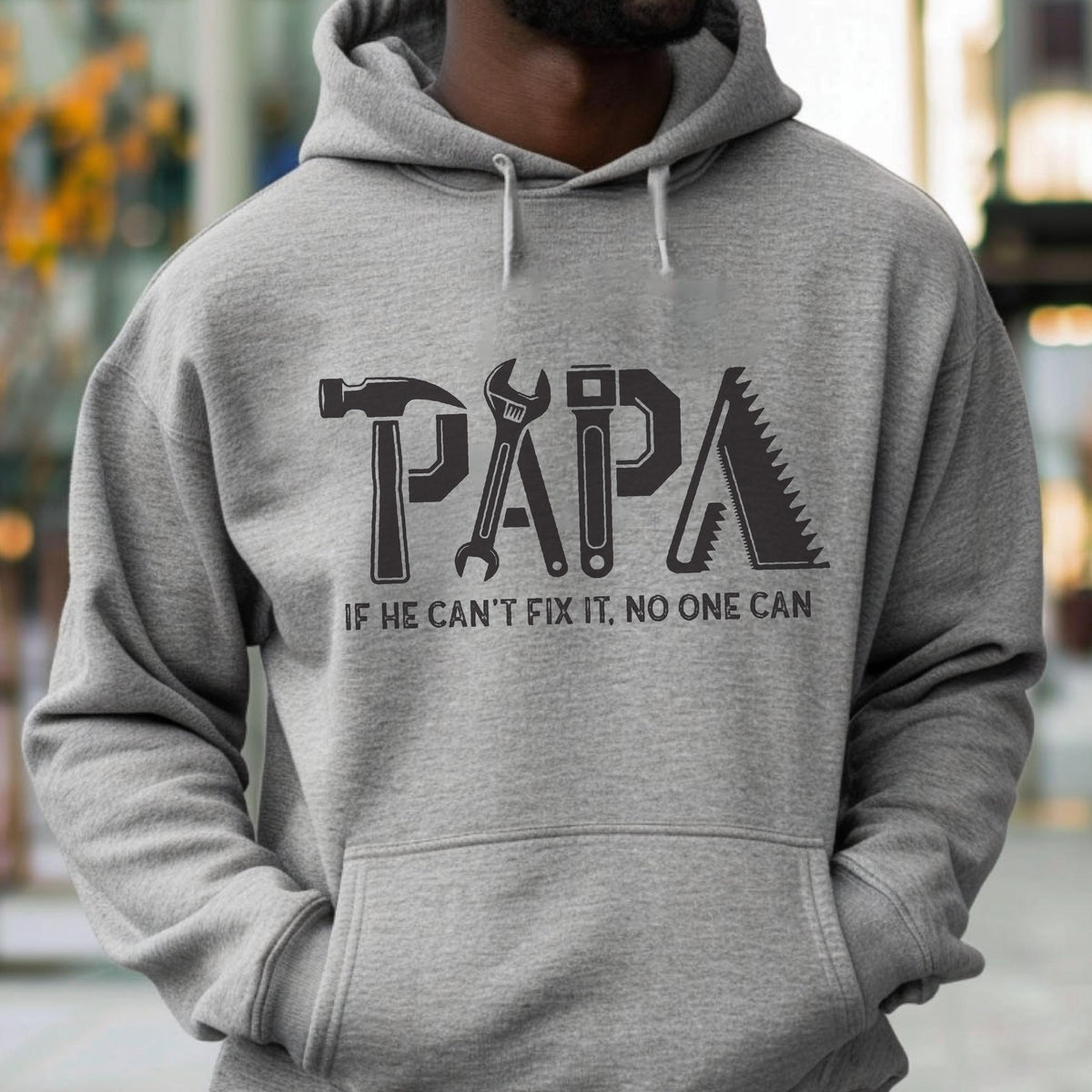 May include: Gray hoodie with the word "PAPA" in a tool-themed design. The letters are formed by a hammer, wrench, screwdriver, and saw. Below the word is the text: "IF HE CAN'T FIX IT, NO ONE CAN."