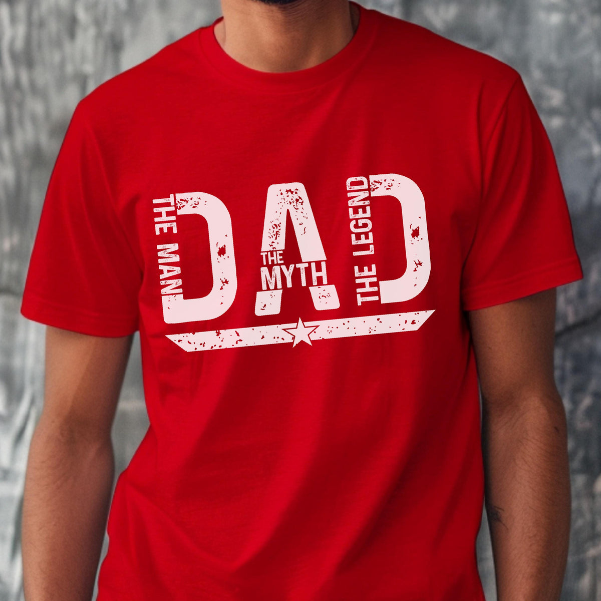 May include: Red t-shirt with white text that reads "DAD" with "THE MAN", "THE MYTH", and "THE LEGEND" in a distressed font. A star is below the word "DAD".