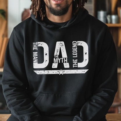 May include: Black hoodie with the text "DAD THE MAN THE MYTH THE LEGEND" in distressed white lettering. A star graphic is below the text. The hoodie is a casual garment.