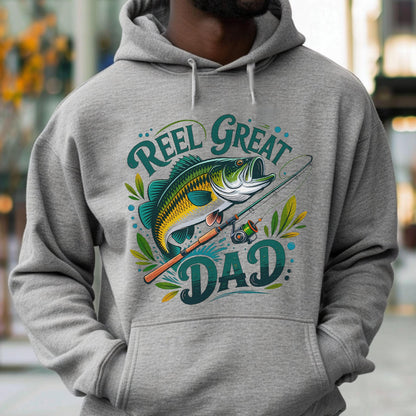 May include: A gray hoodie featuring a graphic of a fish, fishing rod, and the words "Reel Great Dad" in teal and white. The design includes leaves and dots, creating a fishing-themed design.