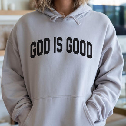 May include: A light gray hoodie with the phrase "GOD IS GOOD" printed in bold, black letters across the chest. The hoodie features a drawstring hood and a front kangaroo pocket.