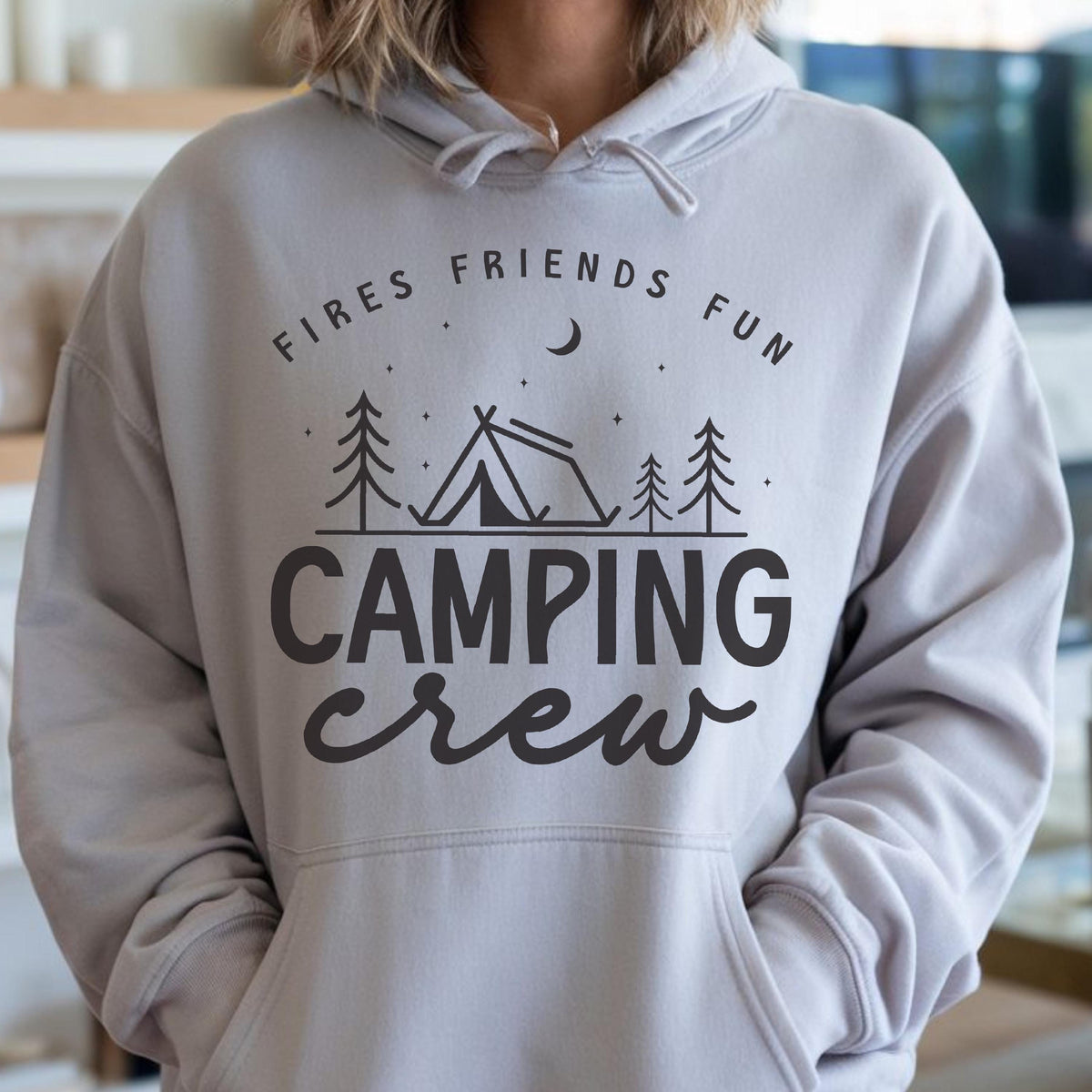 May include: A light gray hoodie with a front pocket and drawstring hood. The graphic on the front reads "Fires Friends Fun" above a tent and trees, with the words "Camping Crew" below.